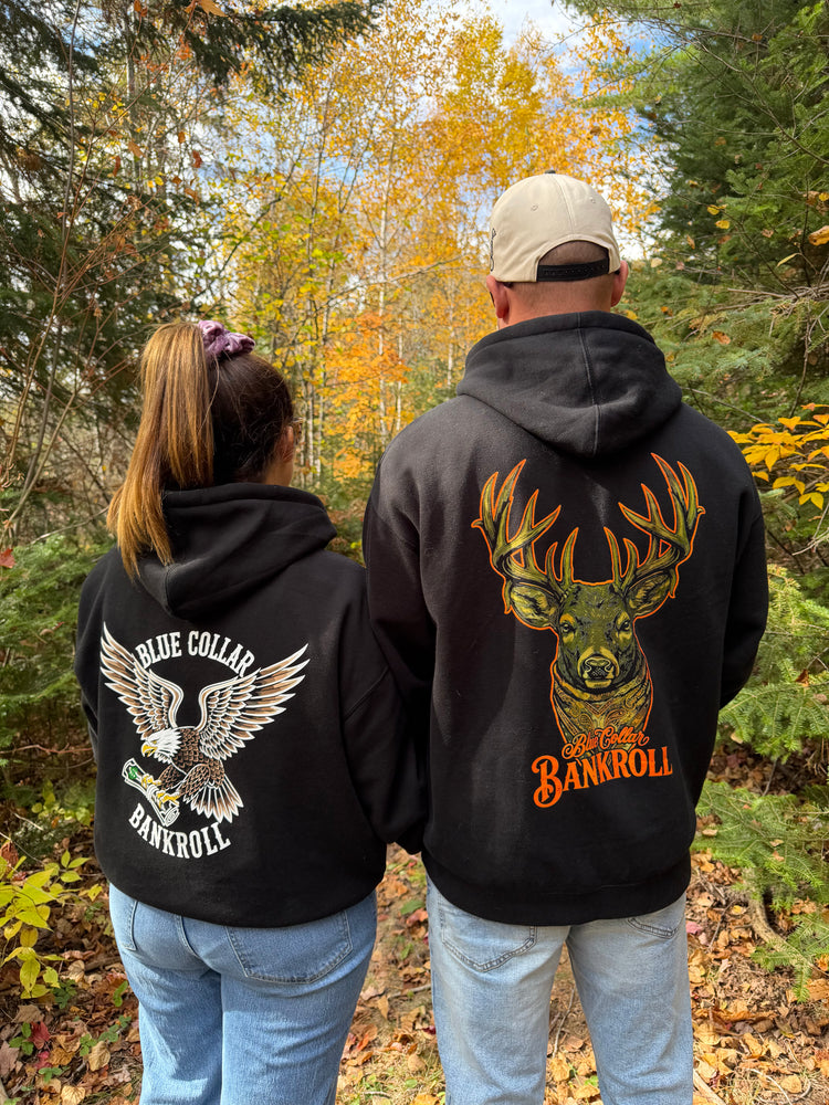 Two customers in Blue Collar Bankroll buck and eagle hoodies in the autumn woods